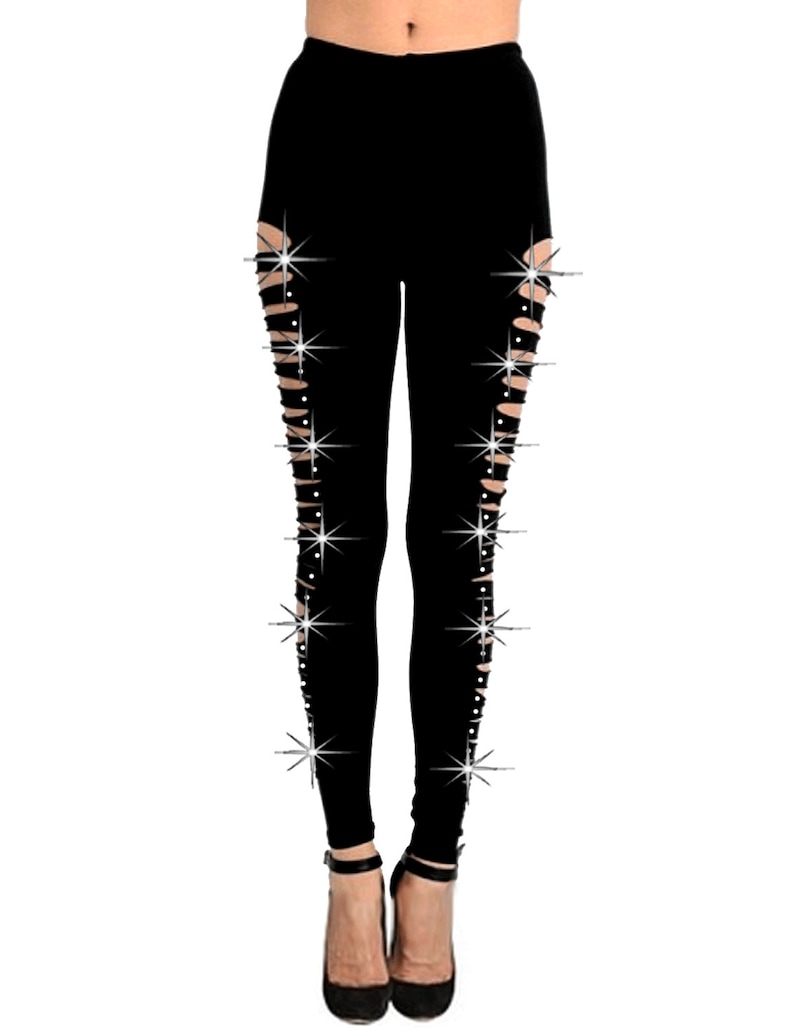 May include: Black leggings with side slits and rhinestone embellishments.
