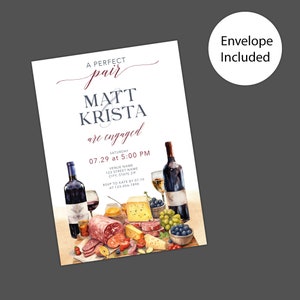 May include: A white invitation card with a watercolor illustration of a cheese and charcuterie board with wine glasses and bottles. The text on the card reads "A perfect pair Matt & Krista are engaged Saturday 07.29 at 5:00 PM VENUE NAME 123 STREET NAME CITY, STATE ZIP RSVP TO KATE BY 07.10 AT 123-456-7890"