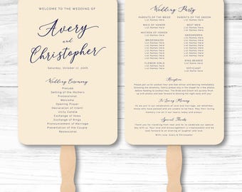 May include: Two cream-colored wedding program fans with wooden handles. The front displays the names Avery and Christopher, the date, and the ceremony order. The back lists the wedding party, reception details, in loving memory, and special thanks.