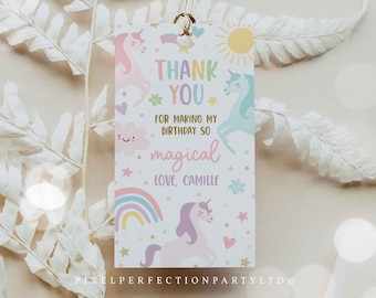 May include: A white thank you tag with a unicorn theme. The tag features a rainbow, stars, hearts, and the text "Thank You for making my birthday so magical. Love, Camille".