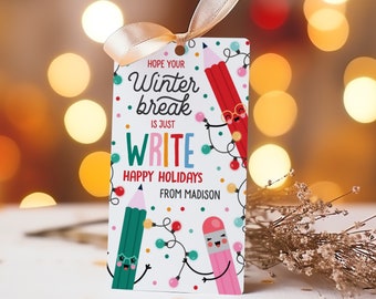 May include: A white gift tag with a red, green, and pink pencil design. The tag says "Hope your winter break is just write. Happy Holidays from Madison".