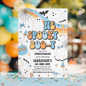 May include: A colorful invitation for a "One Spooky Boo-y" party. The invitation features a rainbow, ghosts, pumpkins, and stars. The text reads "Join us for a Spooktacular party celebrating Sebastian's 1st Boo-Day. Saturday, October 30th, 2pm, Sebastian's Haunted House, 1234 Party Drive, Somerset MA 3678. RSVP Amber at 163-956-789."