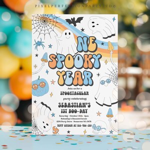 May include: A colorful invitation for a first birthday party with a spooky theme. The invitation features a rainbow, ghosts, pumpkins, and the text "One Spooky Year" in a retro font. The text also includes the party details, such as the date, time, and location.