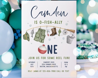 May include: A blue and white birthday invitation for a boy's first birthday party. The invitation features a cartoon illustration of a fishing rod with various fishing gear hanging from it. The text on the invitation reads "Camden is O-Fish-Ally One" and "Join us for some reel fun!" The invitation includes the date, time, and location of the party.