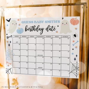 May include: A printable Halloween-themed baby shower game. The game is a calendar with the month of July and August. The game asks guests to guess the baby's birthday date. The calendar is decorated with ghosts, pumpkins, candy corn, and spiderwebs.