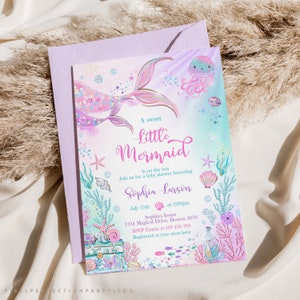 May include: A baby shower invitation with a mermaid illustration. The invitation is decorated with seashells, starfish, and bubbles. The text reads "A sweet little mermaid is on the way. Join us for a baby shower honoring Sophia Larson. July 12th at 2:00pm. Sophia's house 1234 Magical Drive, Boston 5678. RSVP Emma at 123-456-789. Registered at your store here."