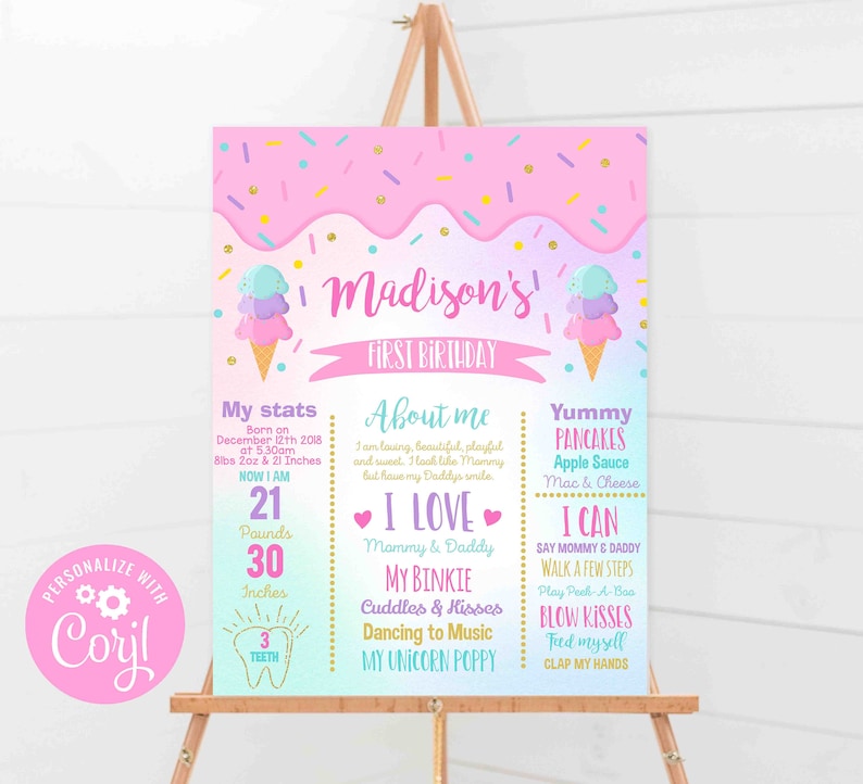 May include: A pink and purple first birthday sign with ice cream cone graphics. The sign includes the name "Madison" and details about the child's birth, including weight (9.5 kg) and height (76 cm).