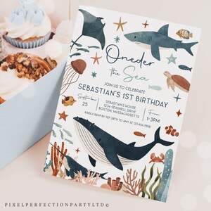 May include: An invitation to a first birthday party with an under the sea theme. The invitation features a whale, a shark, a stingray, a turtle, and other sea creatures. The text on the invitation reads "Oneder the Sea" and "Sebastian's 1st Birthday".