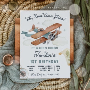 May include: A blue and brown airplane illustration with clouds and stars. The text "oh, how time flies!" is at the top of the invitation. The text "Fly on over to celebrate Jordan's 1st Birthday" is below the airplane. The invitation includes the date, time, and location of the party. The text "RSVP Emily at 123-456-7890" is at the bottom of the invitation.