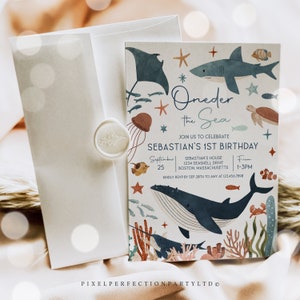 May include: A blue and white invitation card with a whimsical ocean theme. The card features a whale, a shark, a stingray, a jellyfish, a turtle, and other sea creatures. The text on the card reads "Oneder the Sea" and "Sebastian's 1st Birthday".