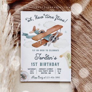 May include: A white invitation with a blue and brown airplane illustration. The text reads "Oh, how time flies!" and "Fly on over to celebrate Jordan's 1st Birthday". The invitation includes details for the party, including the date, time, location, and RSVP information.