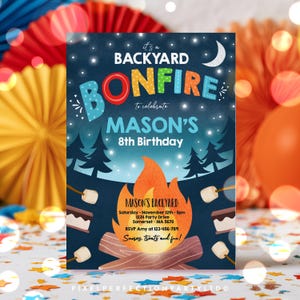 May include: A rectangular invitation card for a backyard bonfire 8th birthday party for Mason. The dark blue night sky features a crescent moon and stars above a forest silhouette. A large orange campfire with logs and s'mores are illustrated.