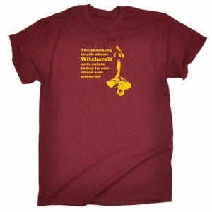 May include: A maroon t-shirt with yellow text and a graphic. The text reads "The shocking truth about Witchcraft as it exists today in our cities and suburbs!" The graphic is a stylized illustration of a person.