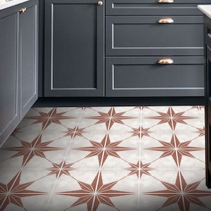 May include: A kitchen with dark grey cabinets and white worktops. The floor is tiled with a white and brown star pattern.