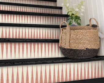 May include: Black painted wooden stairs with a red and white geometric patterned stair riser. A woven basket with a black base sits on the stairs.