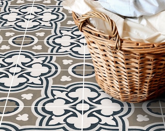 May include: A wicker laundry basket filled with white and blue clothing sits on a patterned floor with a geometric design in shades of gray, white, and blue.