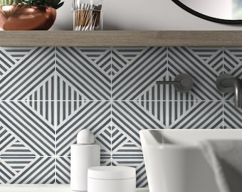 May include: White bathroom sink with a black faucet and a white countertop. The wall behind the sink is tiled with white and gray geometric tiles.