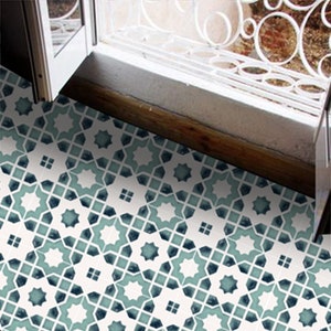 May include: A white floor with a repeating geometric pattern in shades of blue and green. The pattern is made up of stars and squares.