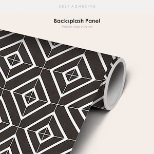 May include: A roll of self-adhesive backsplash panel with a black and white geometric pattern. The panel is rolled up and the end of the roll is visible. The text "Backsplash Panel" and "Panels ship in a roll" is visible on the image.