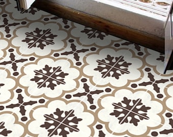May include: A white floor tile with a brown floral pattern. The pattern features a stylized snowflake design within a circular frame.