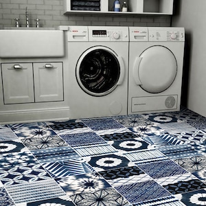 May include: A white washing machine and tumble dryer are in a utility room with a blue and white patterned tiled floor.