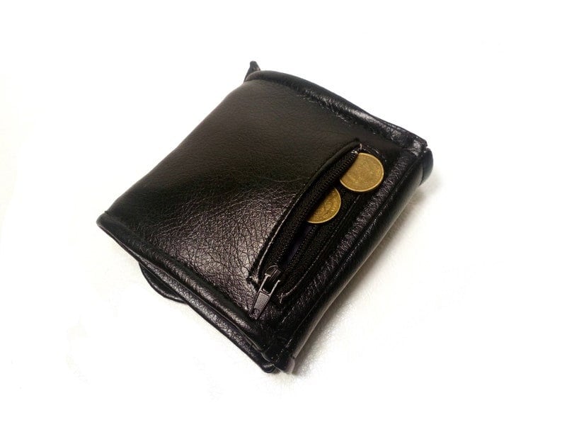 May include: A black leather wallet with a zippered pocket and three gold coins inside.