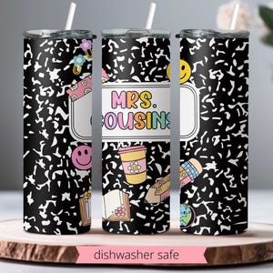 May include: Three stainless steel tumblers with black and white notebook paper designs. The tumblers have different text on them, including "Mrs. Cousins".