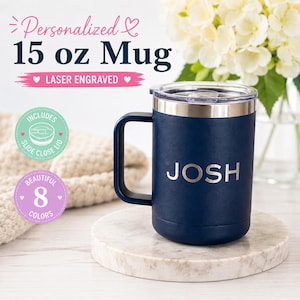 May include: A navy blue 15 oz mug with a silver lid and handle, personalized with the name "JOSH". The mug includes a slide-close lid and is laser engraved. The image also shows text that says "Personalized", "Laser Engraved", and "8 Colors".
