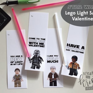 May include: Four printable Valentine's Day cards featuring Lego Star Wars characters. The cards feature Rey, Kylo Ren, Han Solo, and Finn. The text on the cards reads: "You are a Rey of light in my life!" "Come to the dark side with me, Valentine!" "I like you Solo much!" and "Have a Finn-tastic day, Valentine!"