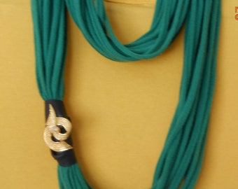 Green infinity scarf with gold tone decorative accent