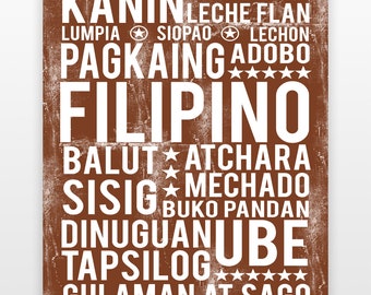 May include: A brown rectangular print with white text featuring Filipino food names. The word "FILIPINO" is prominently displayed, surrounded by names like "KANIN", "LUMPIA", "SISIG", and "UBE". Stars and circles accent the text.