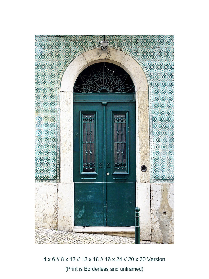 May include: A green wooden door with a decorative iron grate and a white archway. The door is set against a background of blue and white patterned tiles.