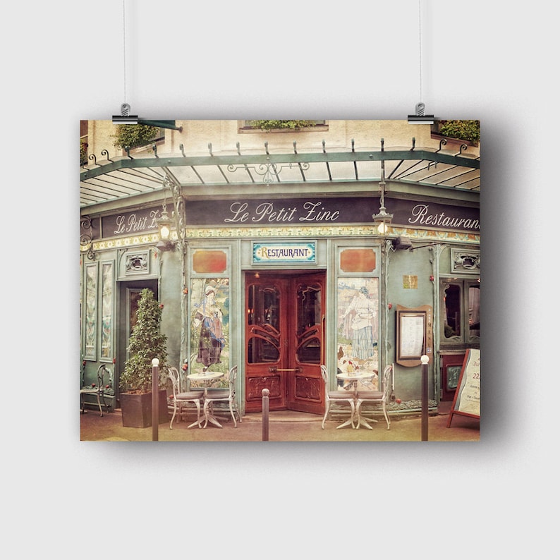 May include: A vintage-style Parisian restaurant called "Le Petit Zinc" with a green awning and a red door. The restaurant has a sign that says "Restaurant" and is decorated with ornate details.