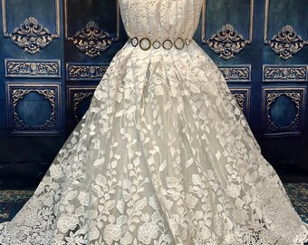 Embroidered white wedding lace with sequins. Feathers design.