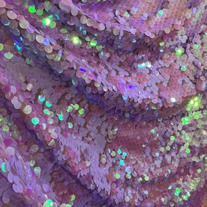 May include: Purple iridescent sequins on a mesh fabric. The sequins are round and have a slight shimmer.