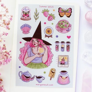 May include: A sticker sheet with a "Summer Witch" theme. It features a cartoon witch with pink hair, a black hat, and various magical elements like butterflies, strawberries, a teacup, and potion bottles. The sheet is on a white background.