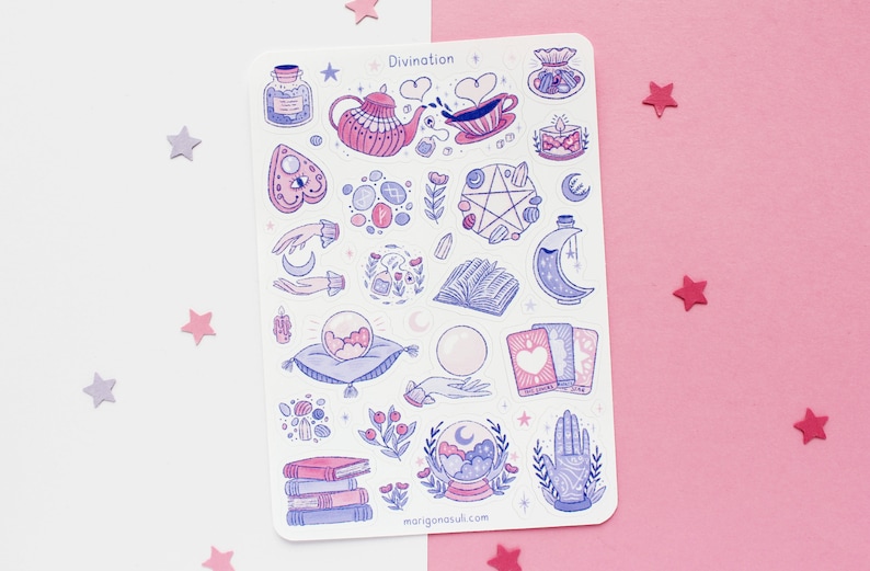 May include: A sticker sheet with various divination-themed illustrations in pink and blue. Designs include a teapot, crystal ball, tarot cards, and a hand with a palmistry design. The word "Divination" is at the top.