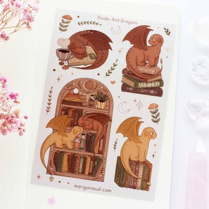May include: A sheet of stickers featuring illustrations of dragons and books. The stickers are on a white background with the text "Books And Dragons" at the top. The stickers are perfect for adding a touch of whimsy to your planner, journal, or laptop.