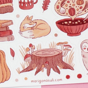 May include: A set of autumn-themed stickers featuring a fox, owl, pumpkin, mushrooms, a bowl of soup, books, and a tree stump. The stickers are illustrated in a watercolor style with warm, earthy tones.