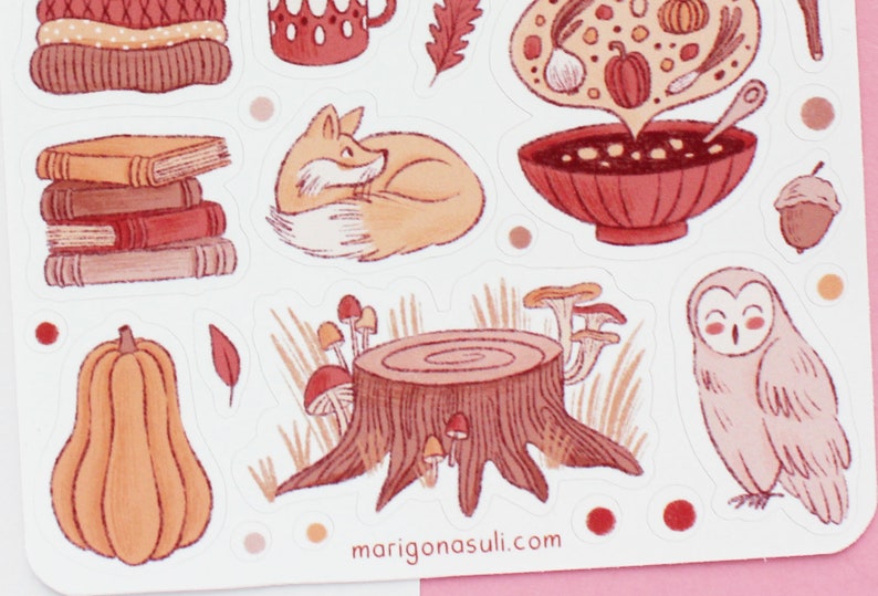May include: A set of autumn-themed stickers featuring a fox, owl, pumpkin, mushrooms, a bowl of soup, books, and a tree stump. The stickers are illustrated in a watercolor style with warm, earthy tones.