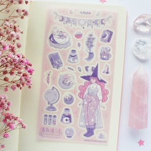 May include: A sheet of pink and purple stickers featuring a witch with a pointed hat, a crescent moon, stars, and other magical elements. The stickers are on a white background and have the text "AGML" and "www.etsy.com/shop/AGML".