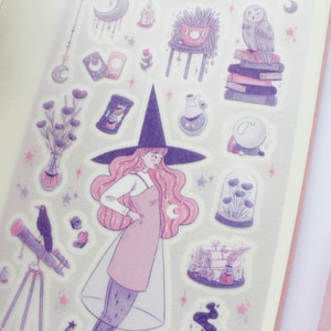 May include: A set of purple and pink witch-themed stickers featuring a witch with a pink dress and a black hat, a telescope, a crystal ball, a potted plant, and a stack of books.