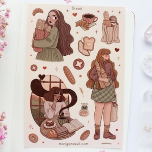 Op de afbeelding: Een stickervel met illustraties van brood, gebak en vrouwen. Het woord "Bread" staat bovenaan. De illustraties omvatten stokbroden, croissants en een vrouw die een broodzak vasthoudt. De website "marigonasuli.com" staat onderaan.