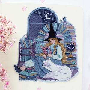 May include: A witch with a pointed hat sits in a room surrounded by books, reading a book with a white cat curled up beside her. The room is decorated with a crescent moon and stars.