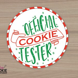 May include: A white circle with a red and white striped border. The text "OFFICIAL COOKIE TESTER" is written in green and red lettering on a white background. The text is surrounded by small snowflakes.
