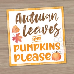 May include: A white sign with brown text that reads "Autumn leaves and pumpkins please". The sign has a woodgrain background and features watercolor illustrations of leaves and a pumpkin.