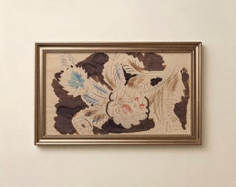 May include: A framed artwork featuring a sketch of flowers on a light tan background. The drawing uses dark brown ink washes, thin black lines, and subtle touches of blue and pink. The frame is a metallic bronze color with a beaded inner edge.