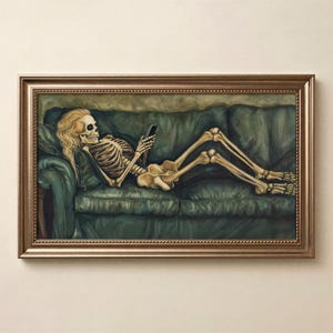 May include: A framed painting depicts a skeleton with long blonde hair, reclining on a green sofa while using a smartphone. The artwork is encased in a gold-colored ornate frame, creating a humorous contrast between the subject and the setting.
