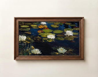 May include: A rectangular framed painting depicting a dark blue pond surface with several white water lilies and numerous green lily pads. The artwork is enclosed in a dark brown wooden frame with a textured, beaded edge detail along the inner border.