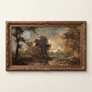 May include: An antique landscape painting in a decorative, ornate, brown wooden frame. The artwork depicts a serene waterside scene with trees, a body of water, and a cloudy sky. The colour palette includes shades of brown, gold, and blue.